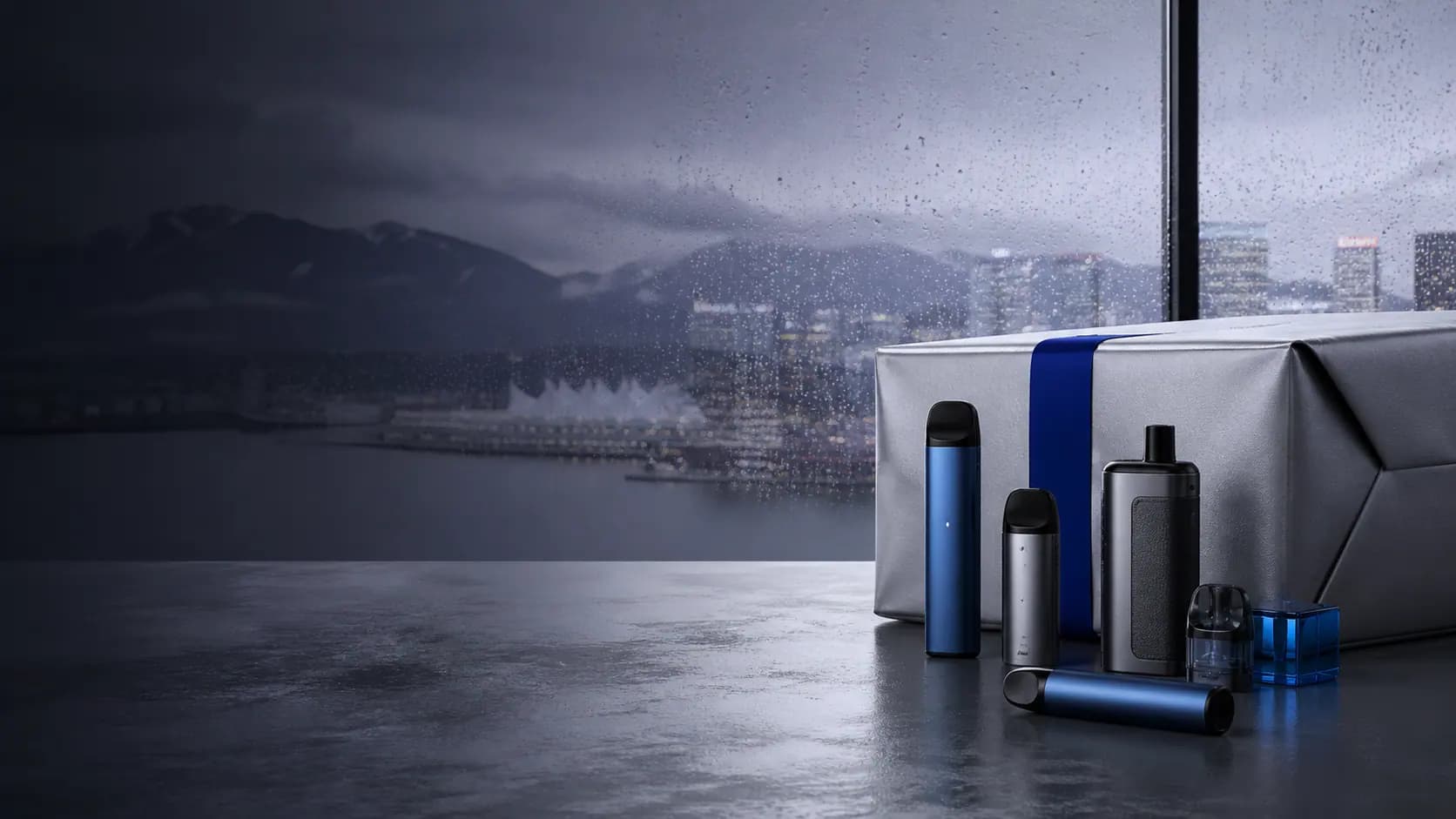 Unbranded vape devices and a parcel in a rain-lit Vancouver studio setting